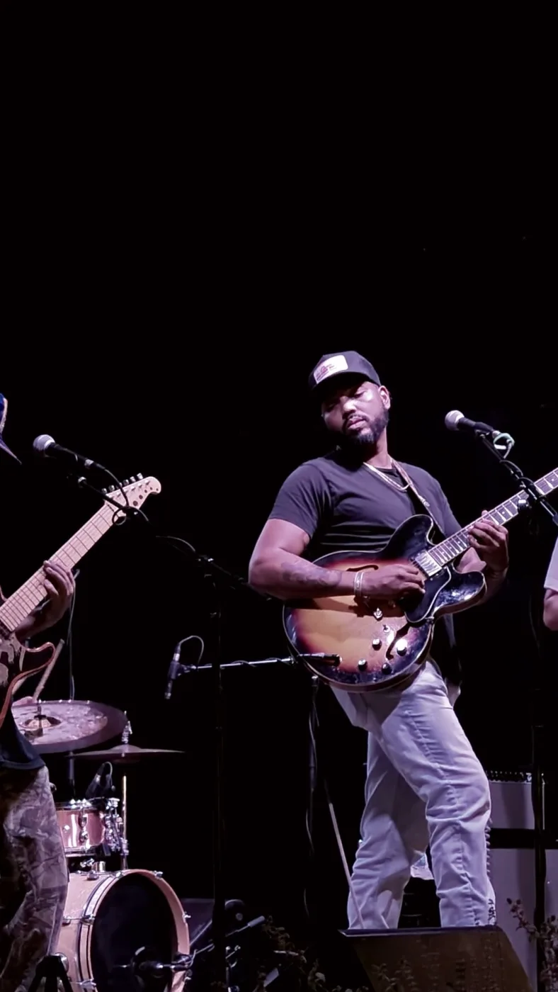 A guitarist on stage at a Pieter Studio live night.