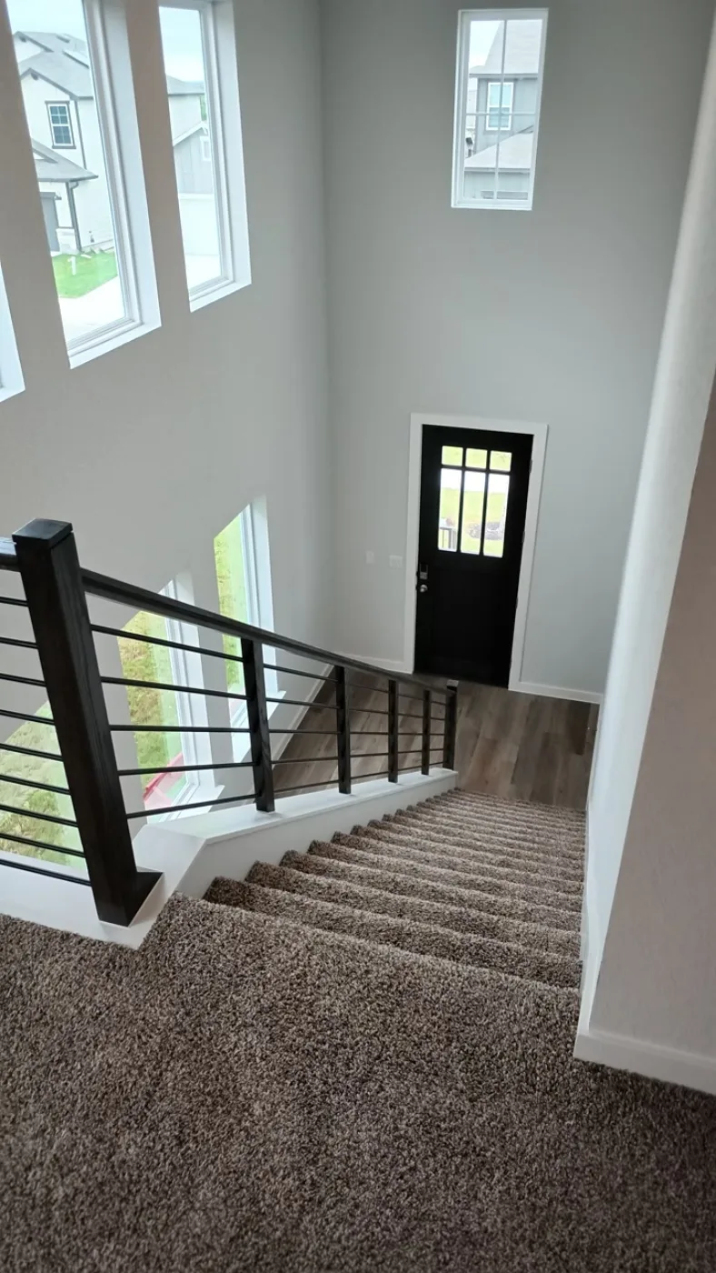 The stairwell of a new-build listing, shot for a member walkthrough.