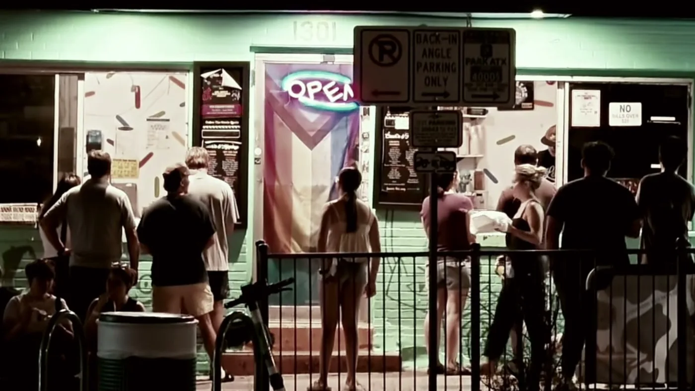 A crowd at an Austin ice cream window at night, from a member neighborhood reel.
