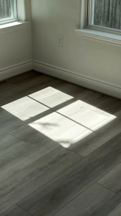 Sunlight across a floor, a vanity, a tile detail.