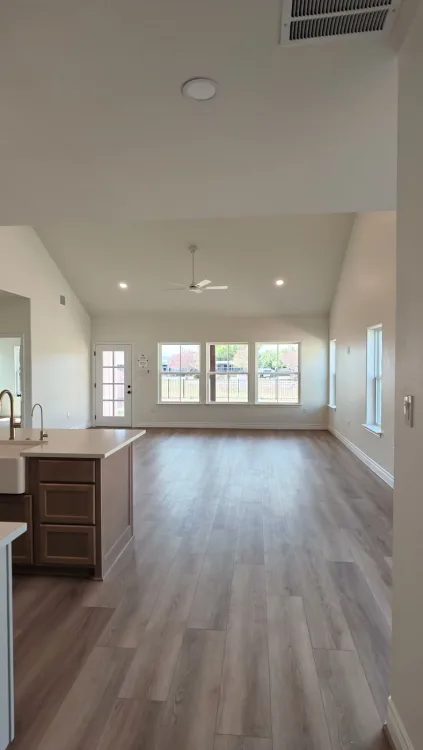 Empty rooms in a freshly finished home, doorway to window.
