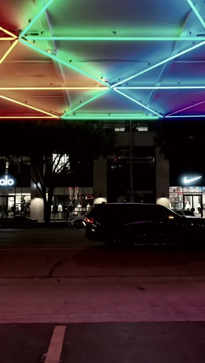 The rainbow neon canopy over a South Congress lot at night.