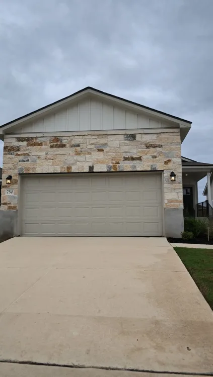 The front of a new-build home under a Texas sky.